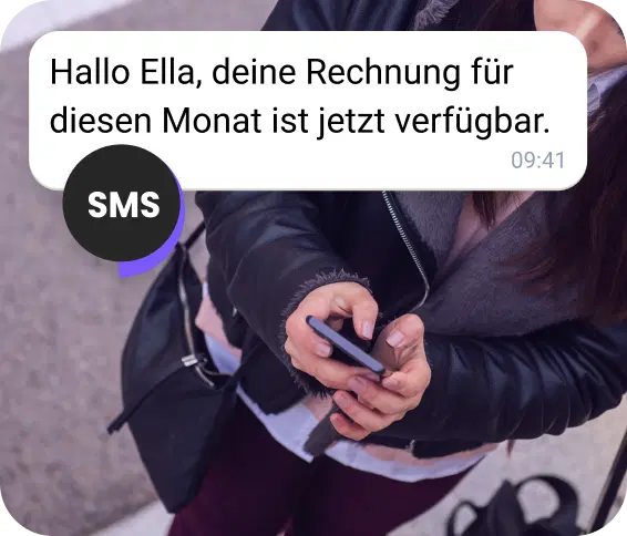 Eine junge Frau erhält eine Abrechnungs-SMS, während sie auf der Straße unterwegs ist.